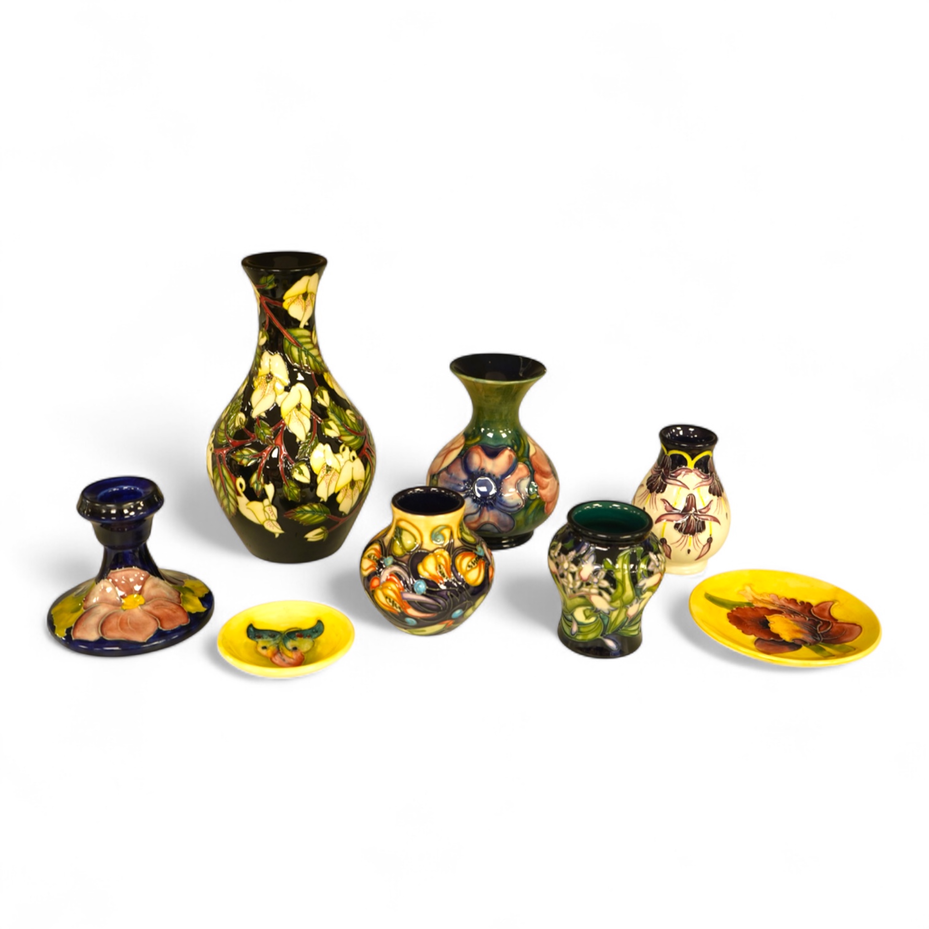 A collection of modern Moorcroft to include a mountain gold pattern vase, two pin dishes and a Hibiscus pattern candlestick, largest 20cm high